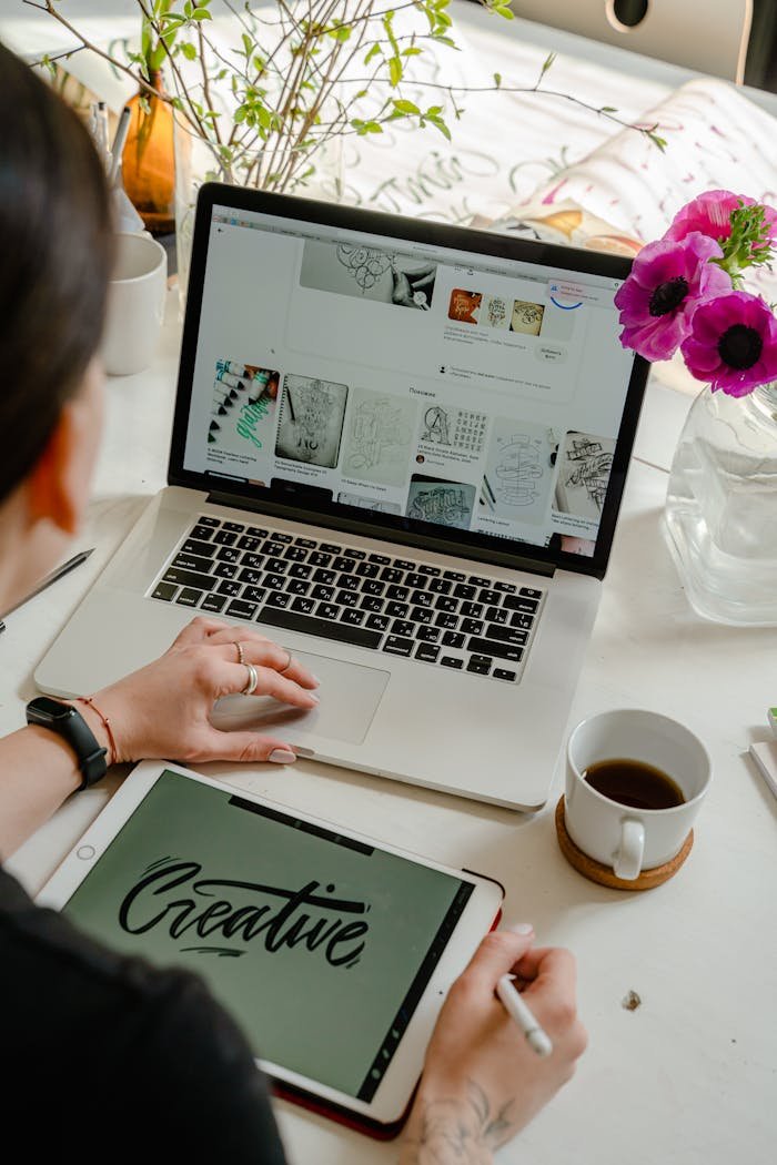 Mastering the First Impression: Your intriguing post title goes here Creative work session featuring a woman using a tablet and laptop for design projects.